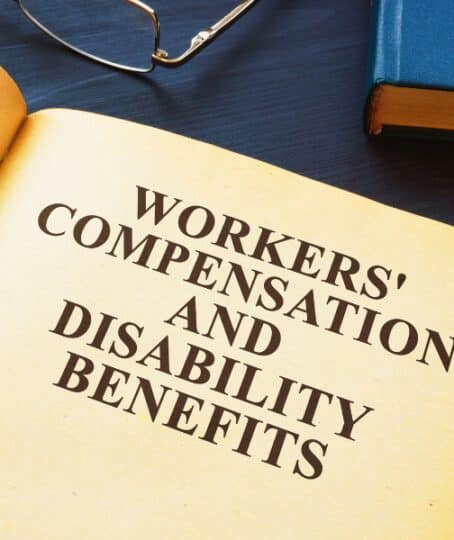 Open Workers Compensation and Disability Benefits law book.