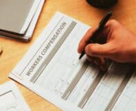 cropped view of man filling in Workers Compensation Accident Injury Concept