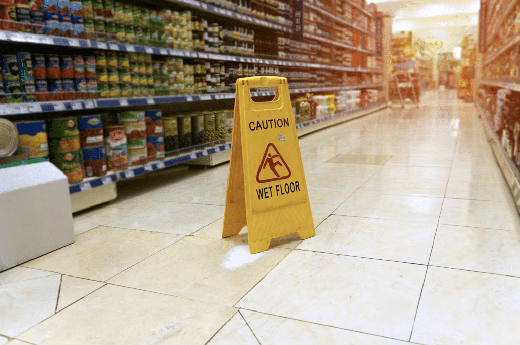 Wet floor sign in a supermarket aisle.