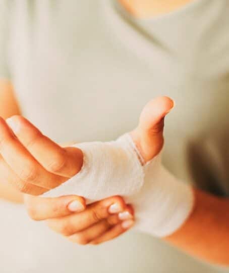 Woman with gauze bandage wrapped around her hand