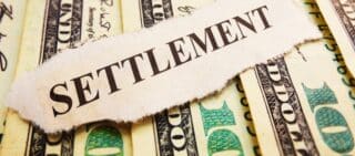 Settlement newspaper headline on money