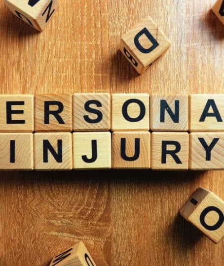 Personal injury text from wooden blocks on desk