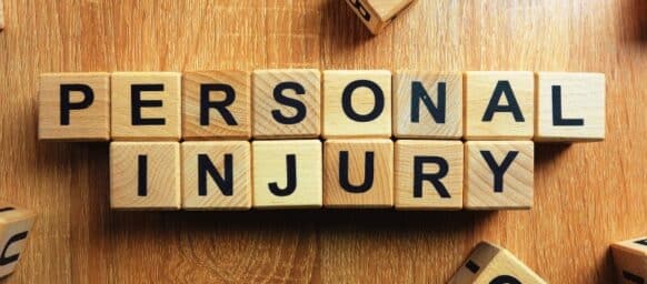 Personal injury text from wooden blocks on desk