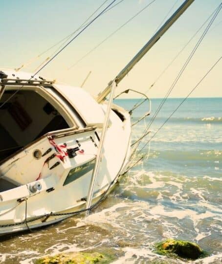 sailboat wrecked and stranded on the beach