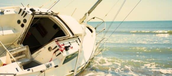 sailboat wrecked and stranded on the beach