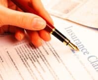 hand filling in insurance claim form. third-party insurance claims