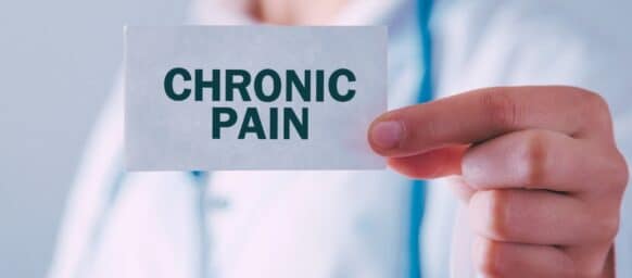 doctor holding chronic pain card
