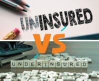 Making uninsured in to insured by eraser. underinsured word or concept represented by wooden letter tiles on a wooden table with glasses and a book
