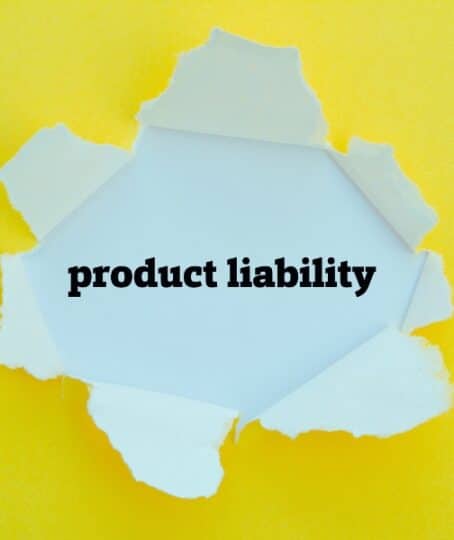 PRODUCT LIABILITY word written under torn paper.