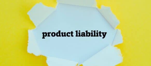PRODUCT LIABILITY word written under torn paper.