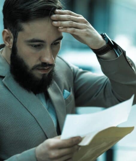 A shocked man reads a court letter