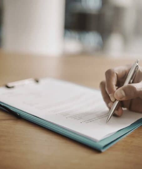 Lawyer hand showing paperwork for signing, agreement contract and settlement offer in law firm office