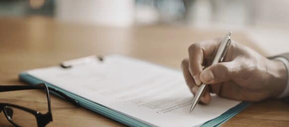 Lawyer hand showing paperwork for signing, agreement contract and settlement offer in law firm office