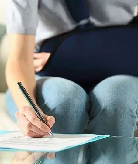 Handicapped woman with sling signing contract.