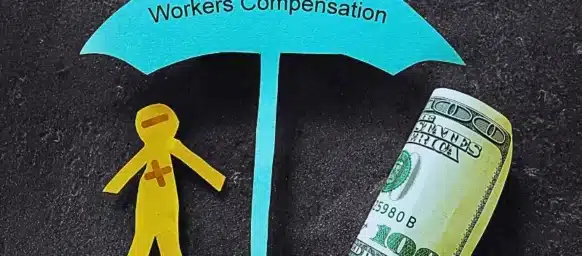 Paper cut shaped person and umbrella with workers compensation written and a hundred dollar bill rolled. What types of injuries or illnesses are covered by workers' compensation