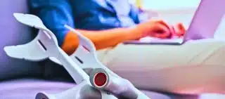 Man With Leg Injury Sitting On Sofa Using Laptop. Can a Personal Injury Claim Be Reopened