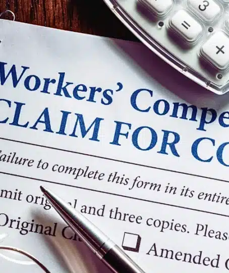 Workers' Compensation form with pen and glasses. employer doesn't carry workers' compensation insurance