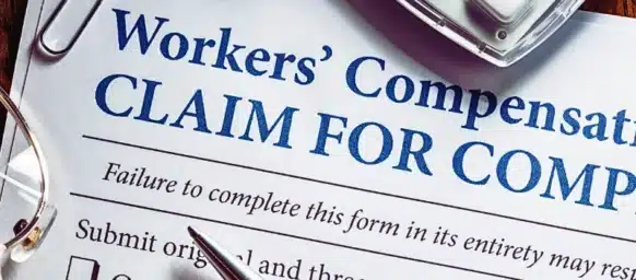 Workers' Compensation form with pen and glasses. employer doesn't carry workers' compensation insurance