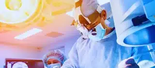 Group of surgeons in operating room with surgery equipment.