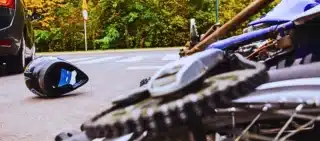 Close-up of the bike and the car on the street. Motorcycle Accidents and Helmet Laws