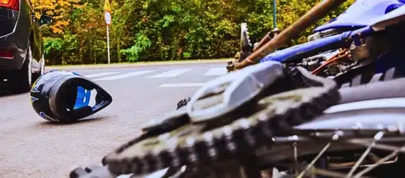 Close-up of the bike and the car on the street. Motorcycle Accidents and Helmet Laws