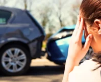 Stressed woman holding head after rear-end car accident. car accident without a police report