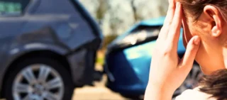 Stressed woman holding head after rear-end car accident. car accident without a police report