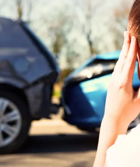 Stressed woman holding head after rear-end car accident. car accident without a police report